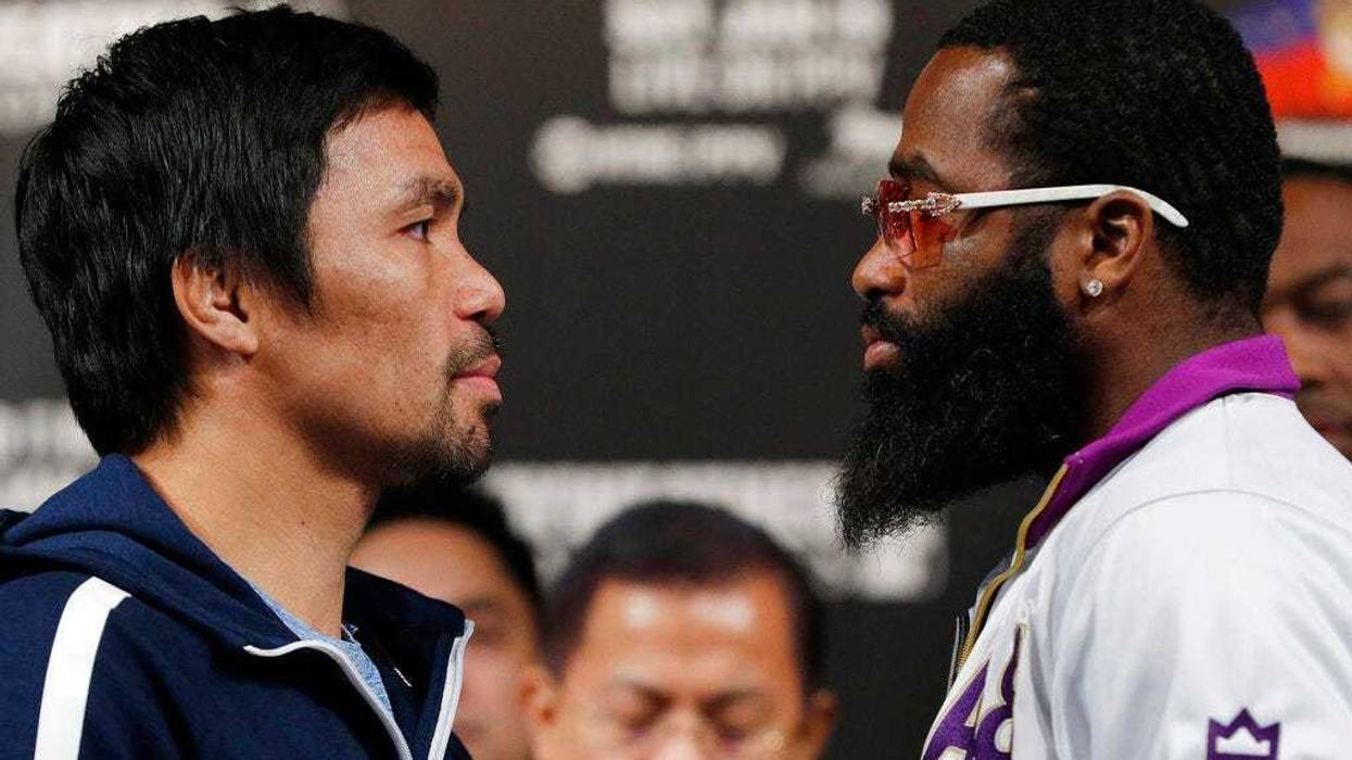 Manny Pacquiao, left, and Adrien Broner pose for photographers during a news conference Wednesday, Jan. 16, 2019, in Las Vegas.