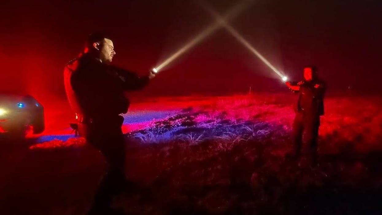 Mansfield police officers take advantage of the fog and use their flashlights as light sabers.