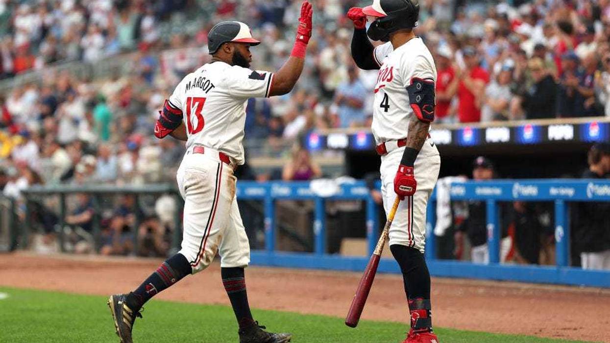 Manuel Margot #13 of the Minnesota Twins celebrates his solo home run against the Detroit Tigers with teammate Carlos Correa #4 in the fifth inning at Target Field on July 02, 2024 in Minneapolis, Minnesota.