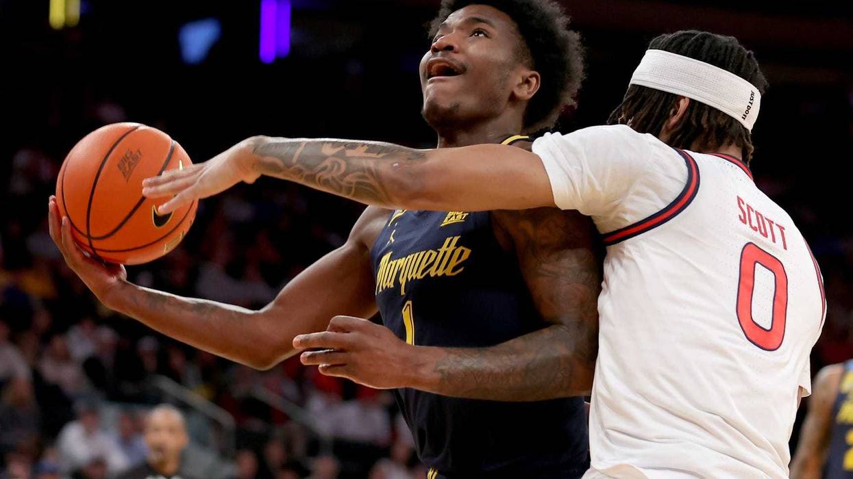 Mar 14, 2025; New York, NY, USA; Marquette Golden Eagles guard Kam Jones (1) drives to the basket against St. John's Red Storm guard Aaron Scott (0) during the first half at Madison Square Garden. Mandatory Credit: Brad Penner-Imagn Images