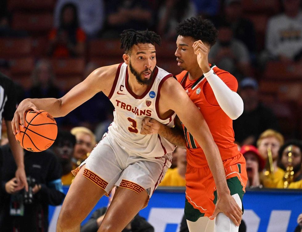 Mar 18, 2022; Greenville, SC, USA; Southern California Trojans forward Isaiah Mobley (3) drives against Miami Hurricanes guard Jordan Miller (11) during the first round of the 2022 NCAA Tournament at Bon Secours Wellness Arena.