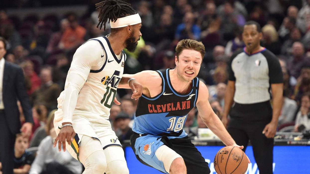 Mar 2, 2020; Cleveland, Ohio, USA;Utah Jazz guard Mike Conley (10) defends Cleveland Cavaliers guard Matthew Dellavedova (18) in the second quarter at Rocket Mortgage FieldHouse.
