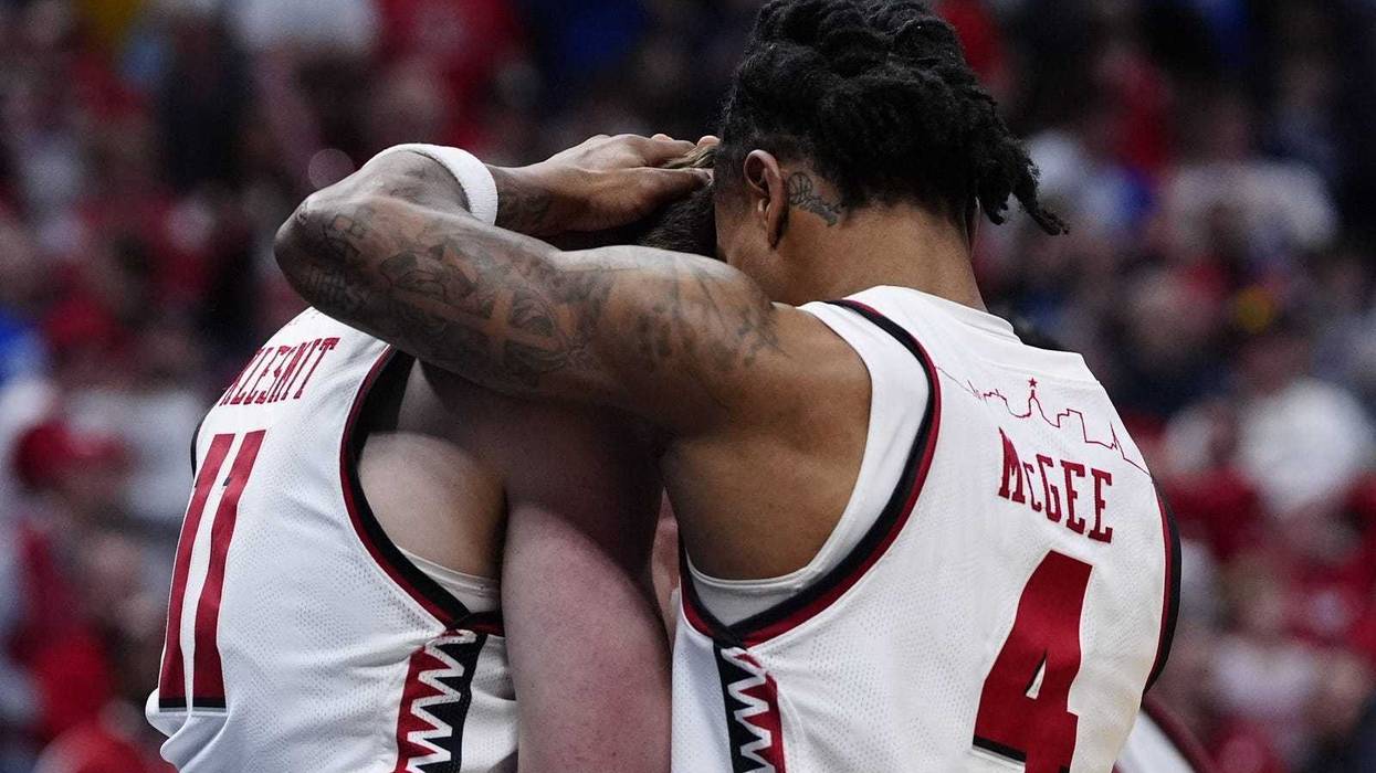 Mar 22, 2025; Denver, CO, USA; Wisconsin Badgers guard Max Klesmit (11) and Wisconsin Badgers guard Kamari McGee (4) react after losing to the Brigham Young Cougars in the second round of the NCAA Tournament at Ball Arena. Mandatory Credit: Ron Chenoy-Imagn Images