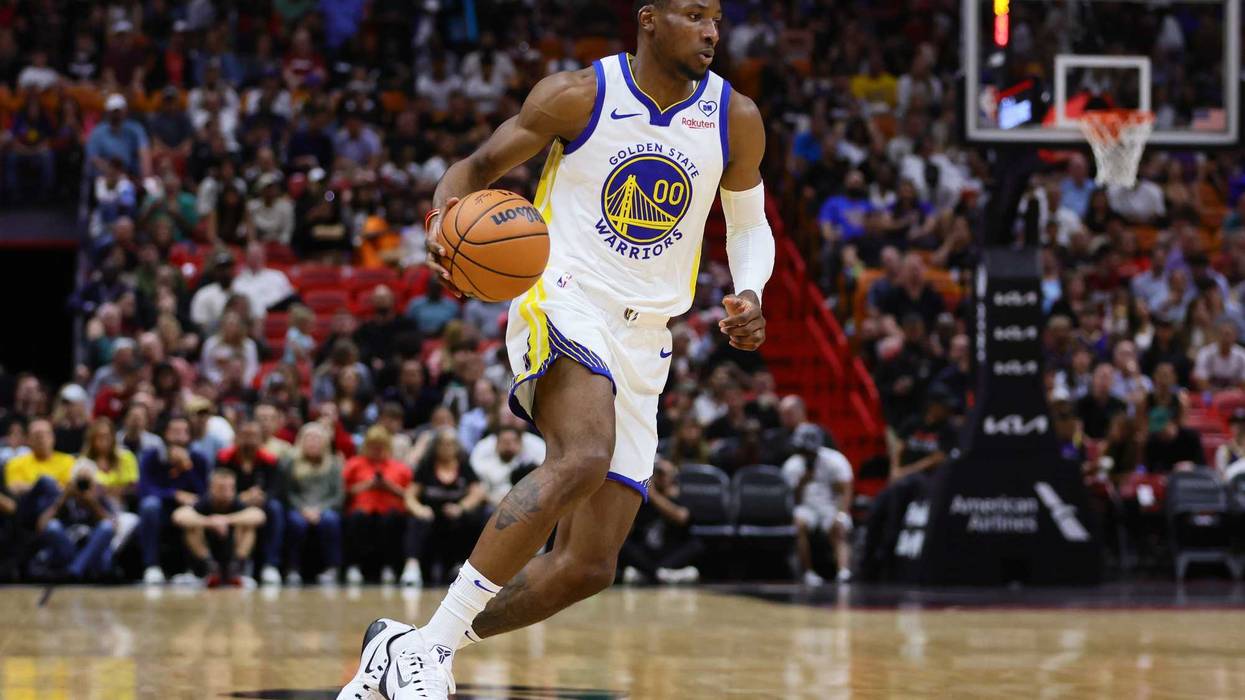 Mar 26, 2024; Miami, Florida, USA; Golden State Warriors forward Jonathan Kuminga (00) dribbles the basketball against the Miami Heat during the first quarter at Kaseya Center.