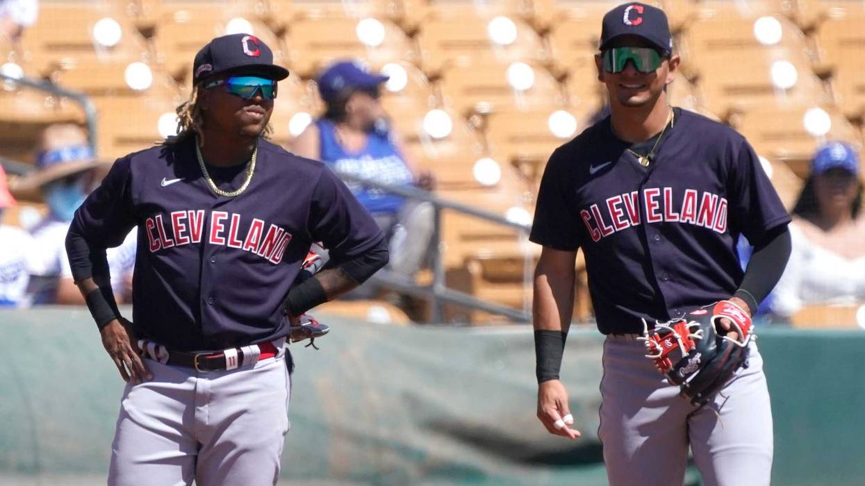 Mar 27, 2021; Phoenix, Arizona, USA; Cleveland Indians third baseman Jose Ramirez (11) and shortstop Andres Gimenez (0) talk during a spring training game against the Los Angeles Dodgers at Camelback Ranch-Glendale.