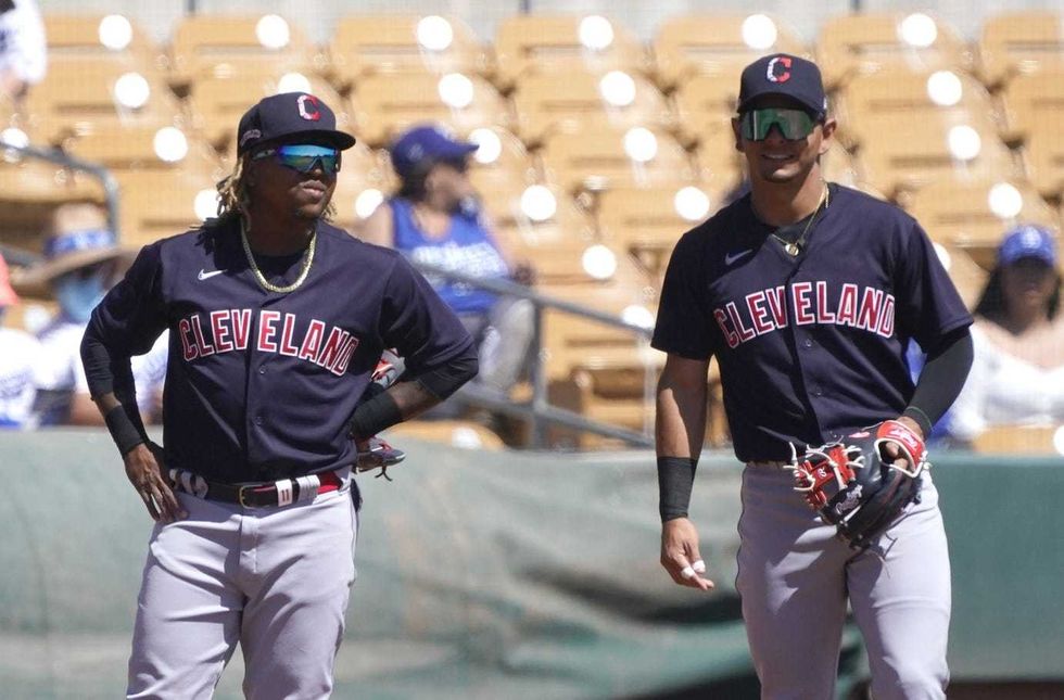 Mar 27, 2021; Phoenix, Arizona, USA; Cleveland Indians third baseman Jose Ramirez (11) and shortstop Andres Gimenez (0) talk during a spring training game against the Los Angeles Dodgers at Camelback Ranch-Glendale.