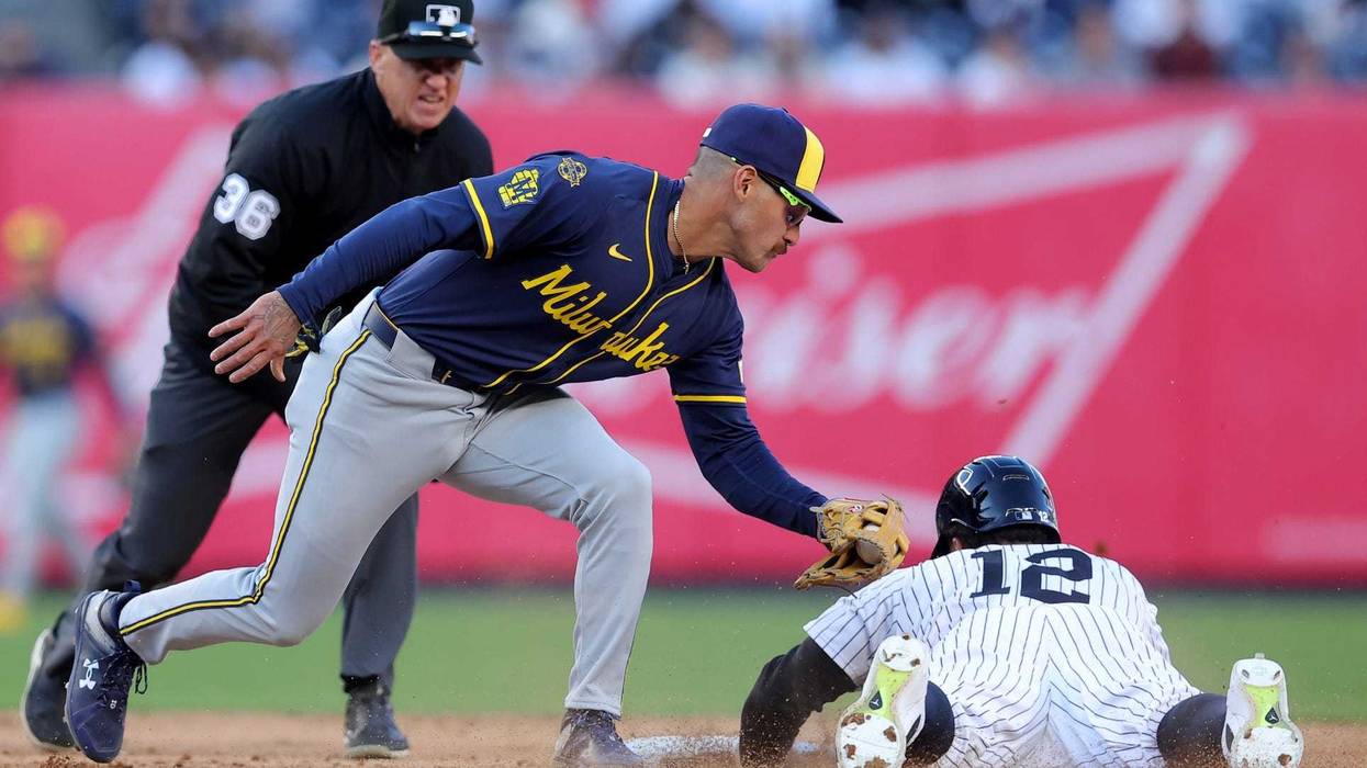 Mar 27, 2025; Bronx, New York, USA; New York Yankees pinch hitter Trent Grisham (12) is tagged out trying to steal second base by Milwaukee Brewers shortstop Joey Ortiz (3) during the eighth inning at Yankee Stadium. Mandatory Credit: Brad Penner-Imagn Images