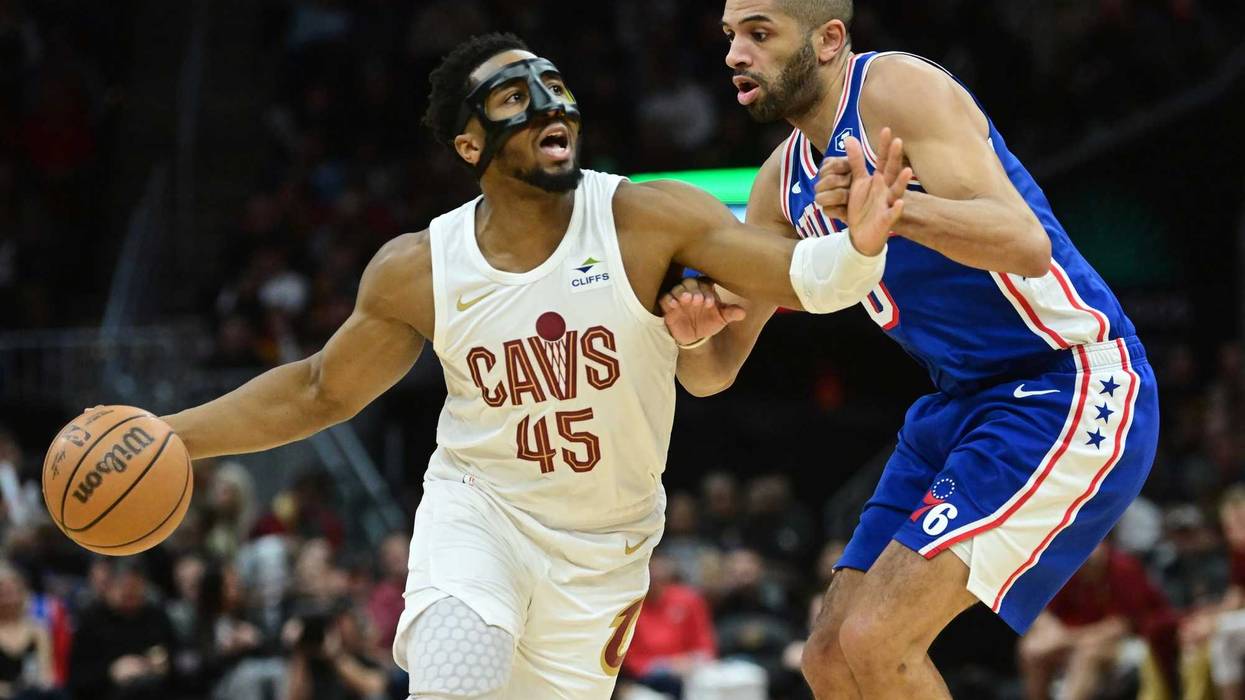 Mar 29, 2024; Cleveland, Ohio, USA; Cleveland Cavaliers guard Donovan Mitchell (45) drives to the basket against Philadelphia 76ers forward Nicolas Batum (40) during the second half at Rocket Mortgage FieldHouse. Mandatory Credit: Ken Blaze-USA TODAY Sports