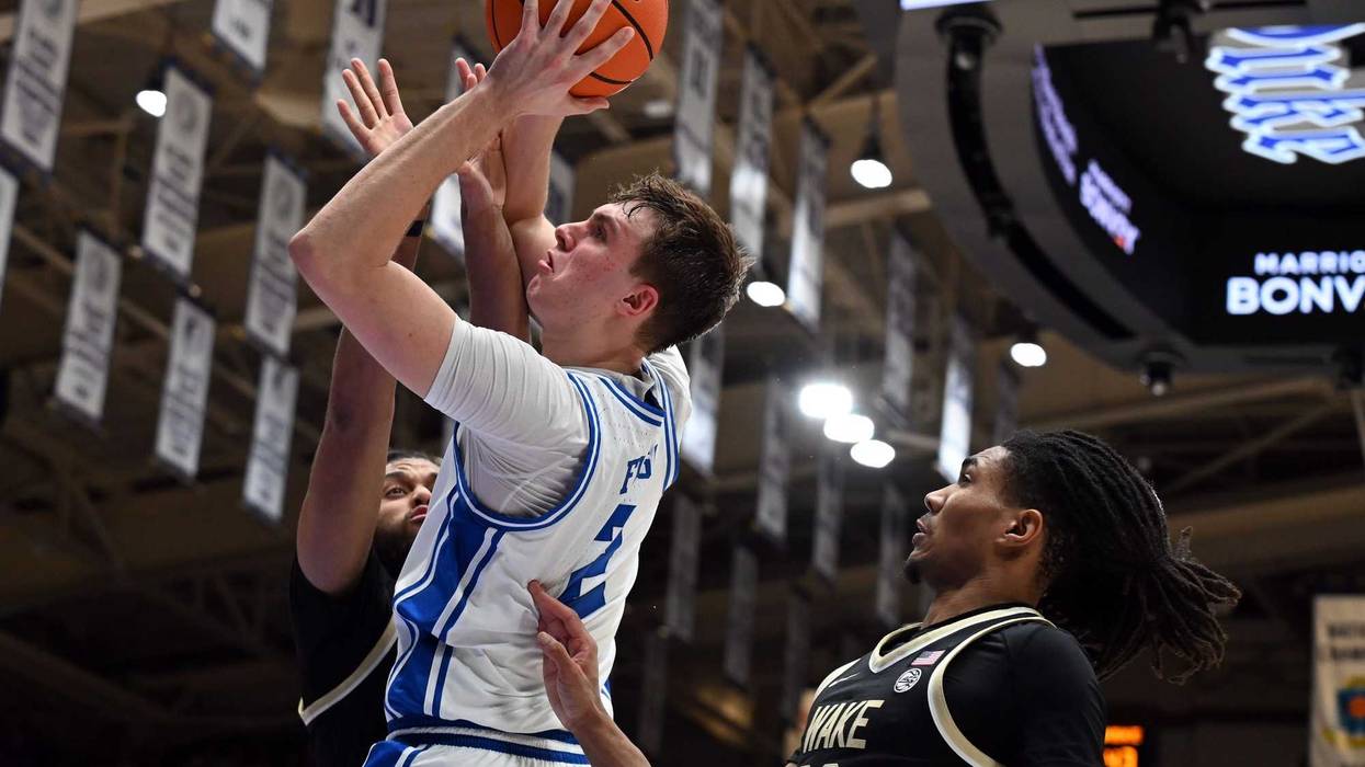 Mar 3, 2025; Durham, North Carolina, USA; Duke Blue Devils forward Cooper Flagg (2) lays the ball up over Wake Forest Demon Deacons center Efton Reid III (4) during the second half at Cameron Indoor Stadium.
