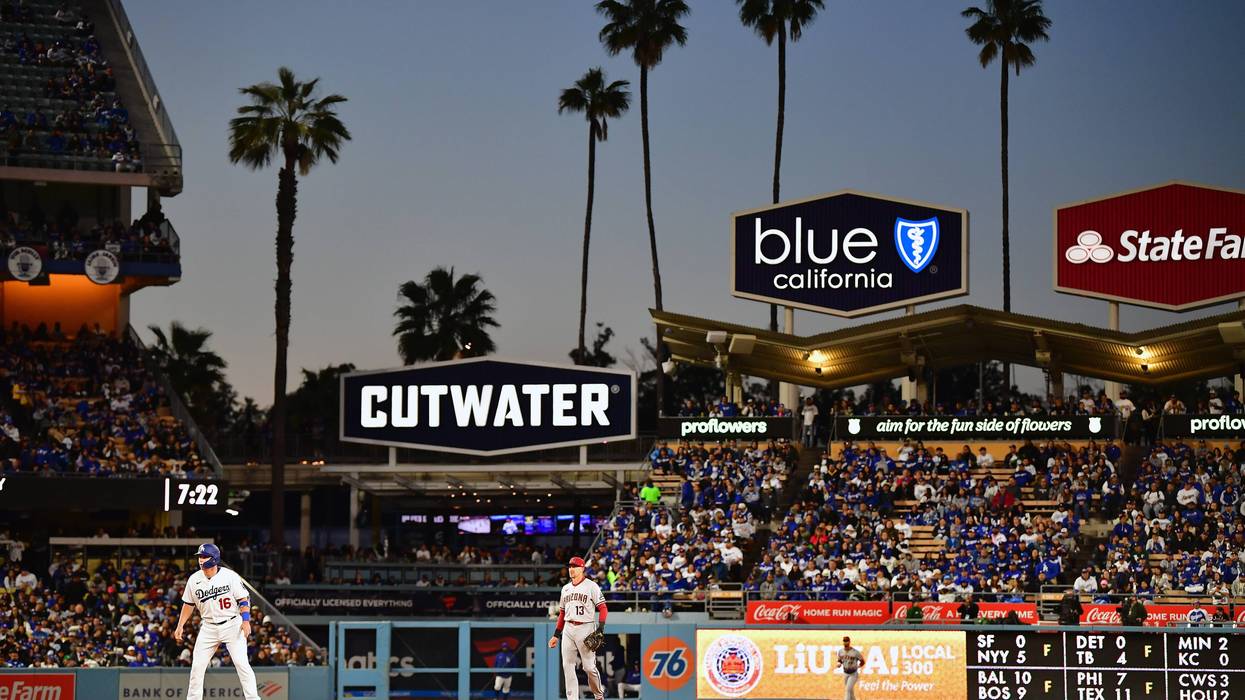 Mar 30, 2023; Los Angeles, California, USA; Los Angeles Dodgers catcher Will Smith (16) leads off from second ahead of Arizona Diamondbacks shortstop Nick Ahmed (13) during the first inning at Dodger Stadium.