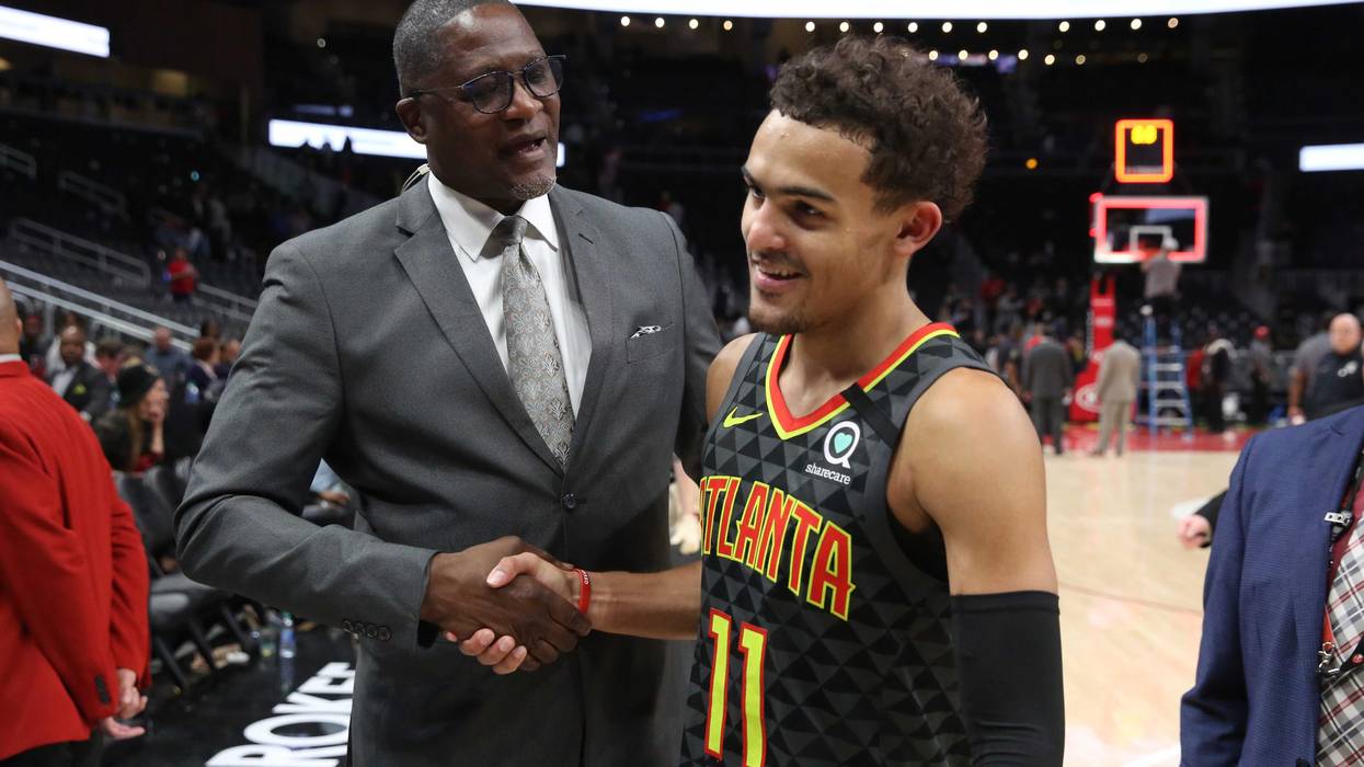 Mar 9, 2020; Atlanta, Georgia, USA; NBA Hall of Fame player Dominique Wilkins, left, congratulates Atlanta Hawks guard Trae Young (11) after their double overtime win against the Charlotte Hornets at State Farm Arena. Mandatory Credit: Jason Getz-USA TODA