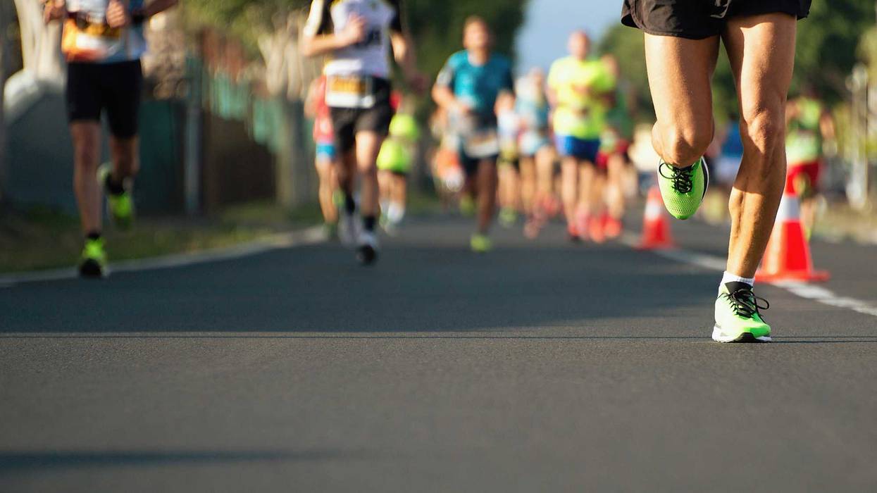 Marathon running race, people feet on city road