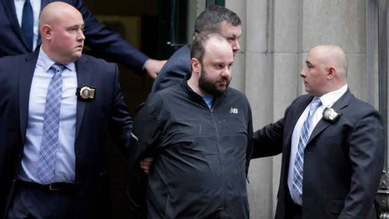Marc Lamparello, 37, center, is escorted out of a police precinct in New York, Thursday, April 18, 2019.