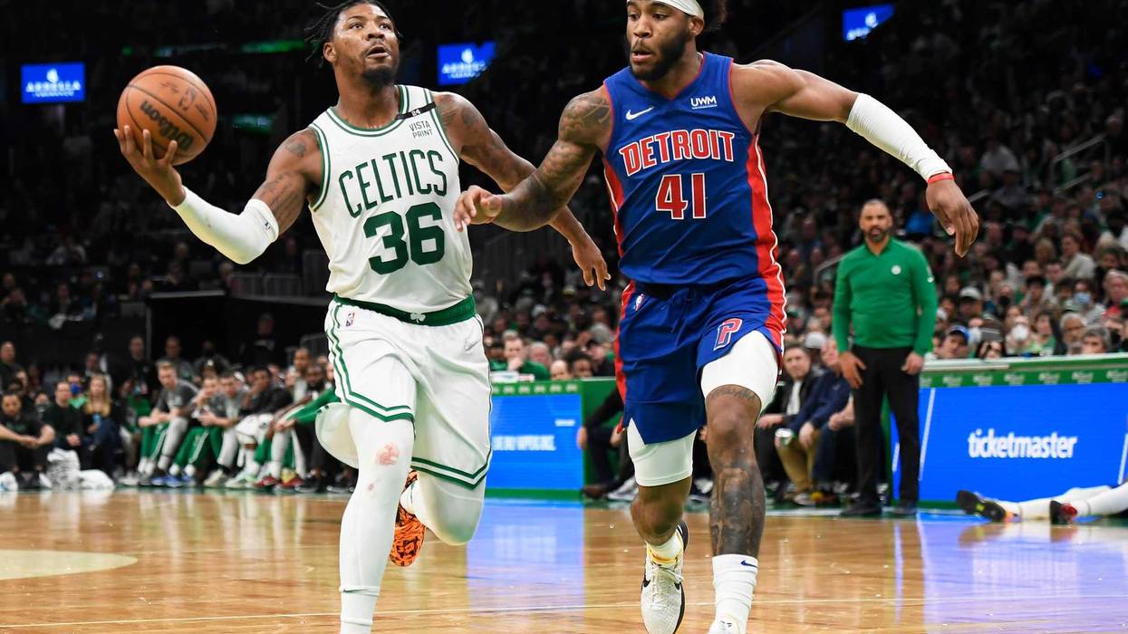 Marcus Smart drives past Saddiq Bey