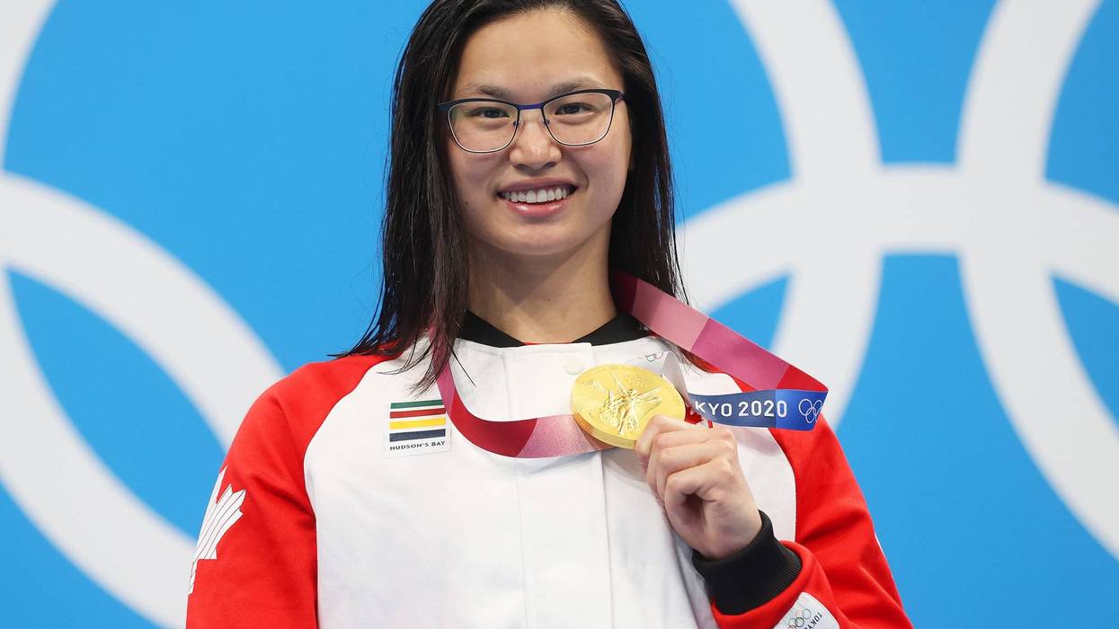 Margaret Macneil of Team Canada poses with the gold medal for the Women's 100m Butterfly Final on day three of the Tokyo 2020 Olympic Games.