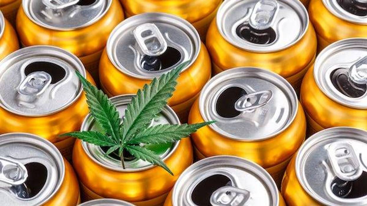 Marijuana leaf on top of golden cans