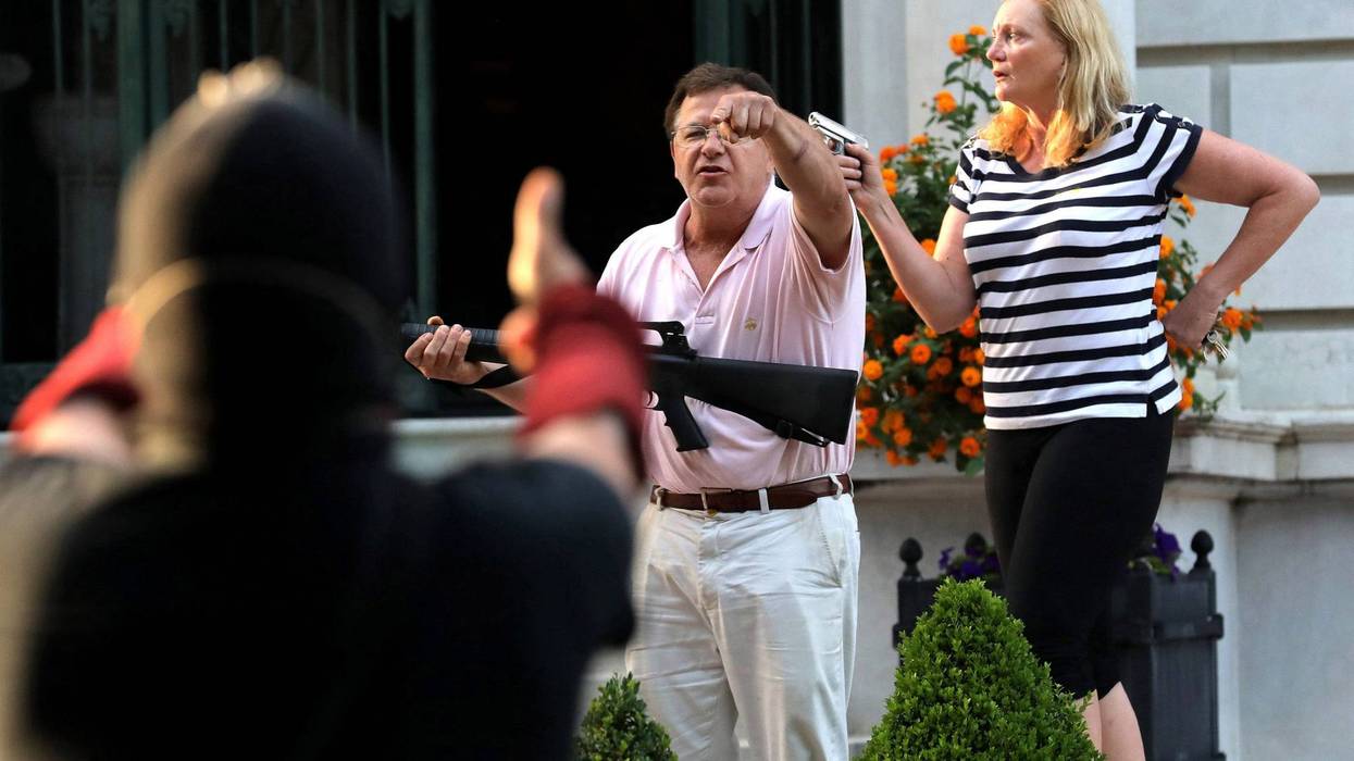 Mark and Patricia McCloskey on porch w Guns