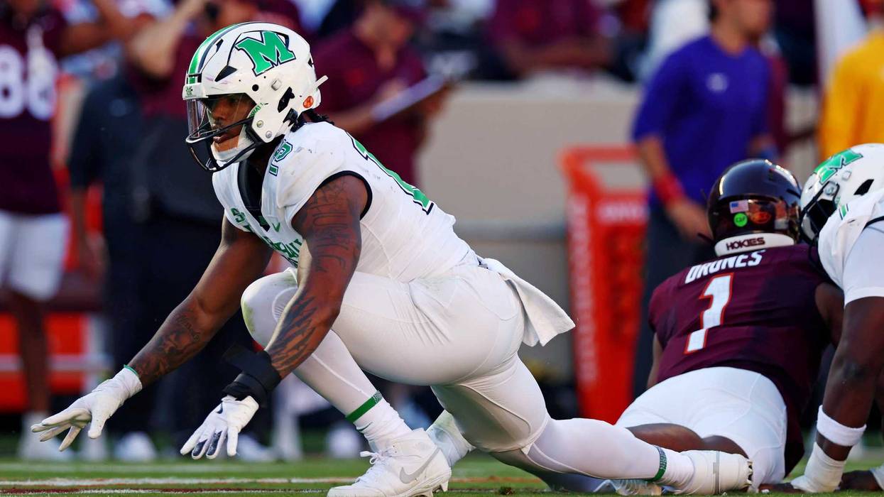 Marshall Thundering Herd defensive lineman Mike Green (15) celebrates after sacking Virginia Tech Hokies quarterback Kyron Drones (1) during the first quarter at Lane Stadium.