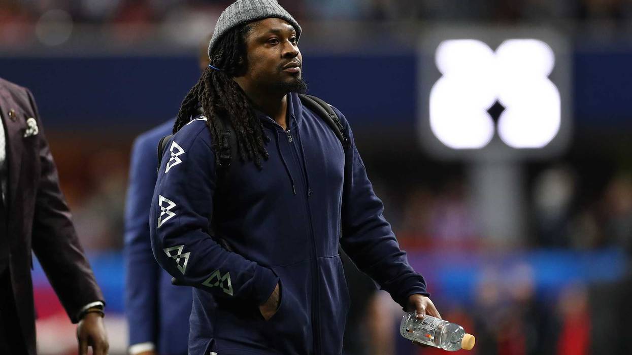 Marshawn Lynch rides around Oakland, handing out masks