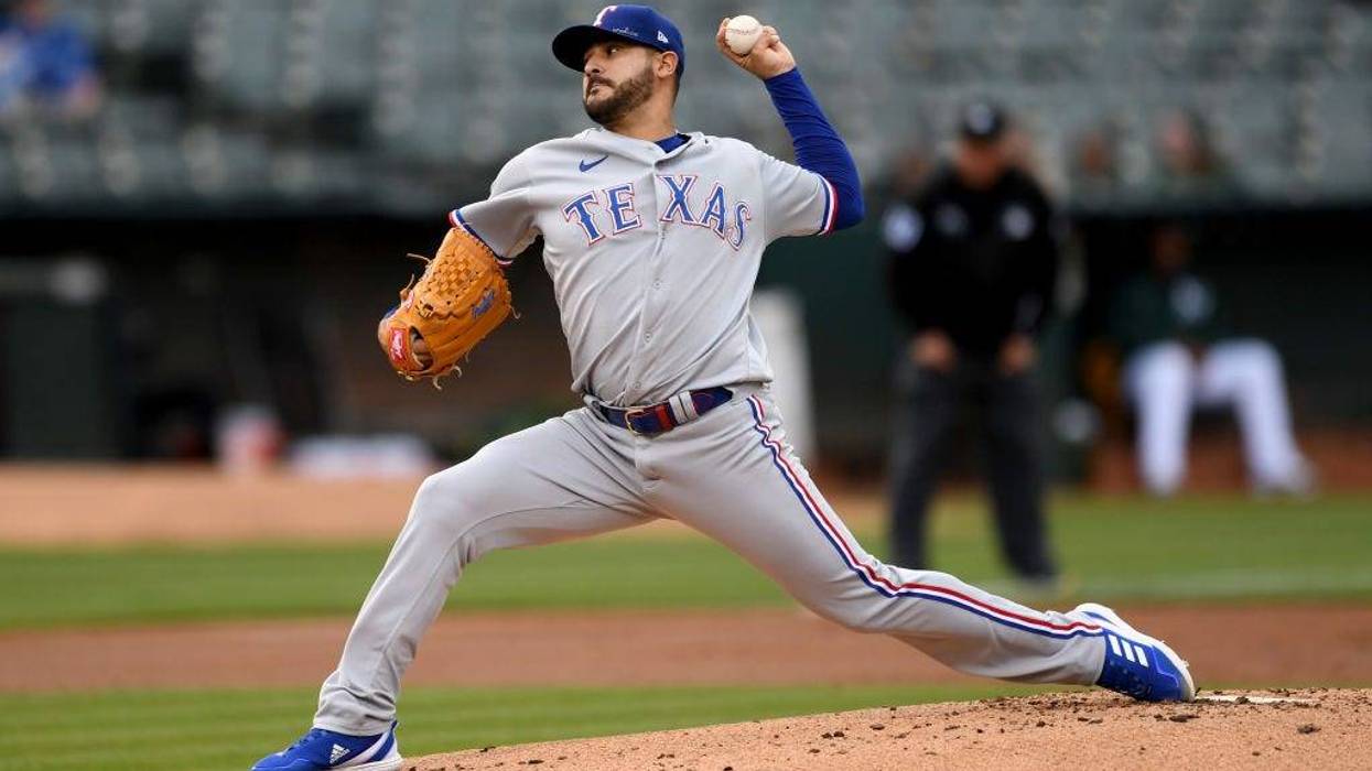 Martin Perez #54 of the Texas Rangers pitches in the bottom of the first inning against the Oakland Athletics at RingCentral Coliseum on May 26, 2022 in Oakland, California.