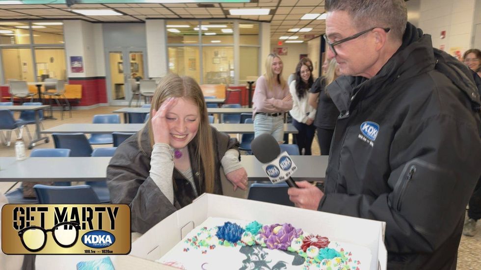Marty Griffin delivering a cake to Anna
