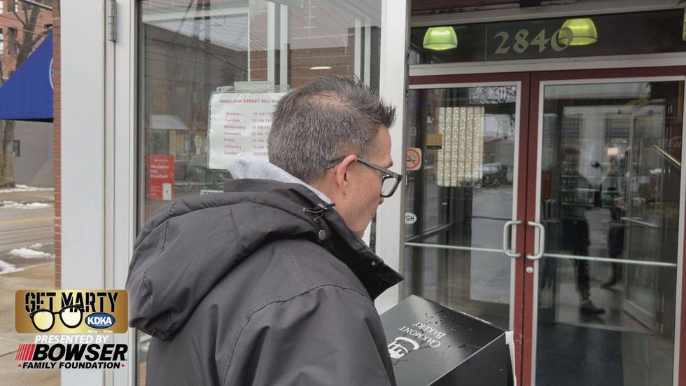 Marty Griffin gets ready to deliver a special cake from Oakmont Bakery.