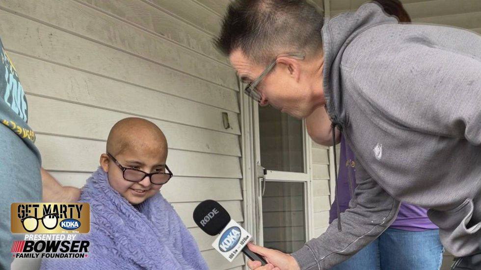 Marty Griffin talks to Jaycee Amick, 12, about her swimming pool