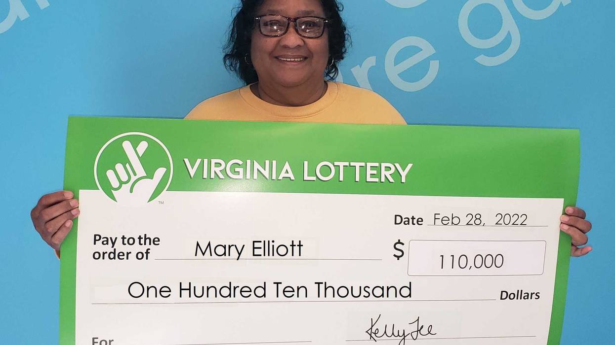 Mary Elliot holding a giant check