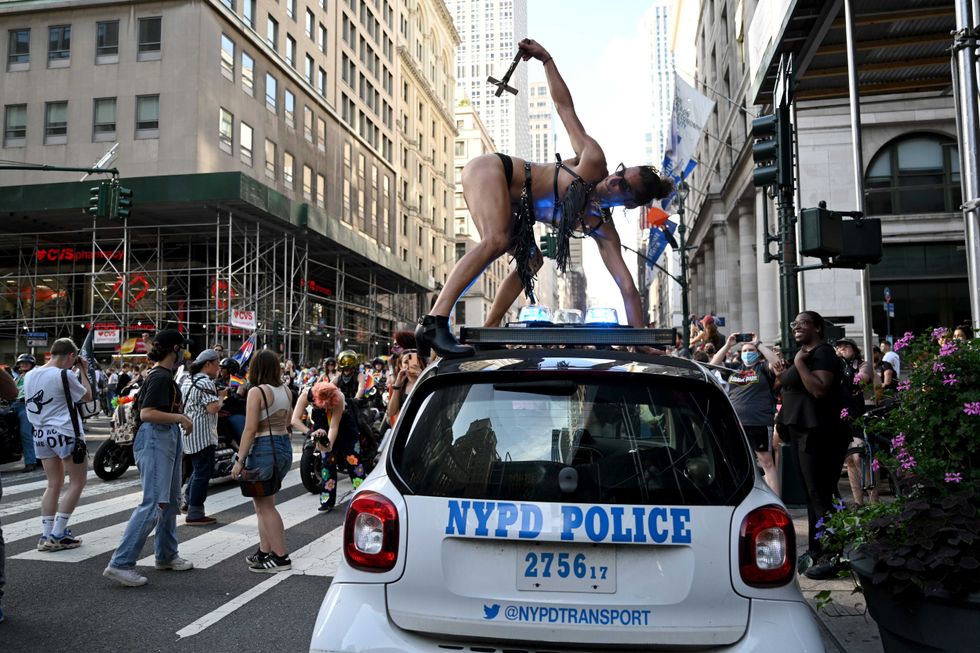 Mary Magdalene dance on top of an NYPD police car during the 29th Annual New York City Dyke March on June 26, 2021 in New York City. The Dyke March which calls itself a march protest, rather than a parade, is a "demonstration of our First Amendment right to protest" according to their website. Due to the coronavirus pandemic the march was held virtually in 2020. This year