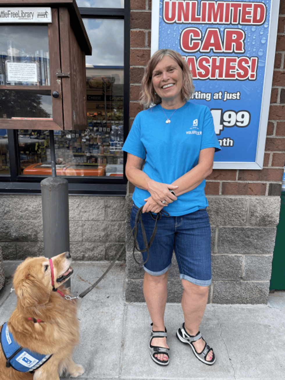 Mary Tiegan smiling with her dog-in-training, Esko