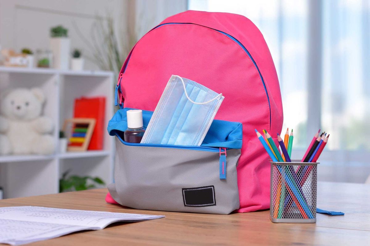 Mask in backpack pocket stock photo.