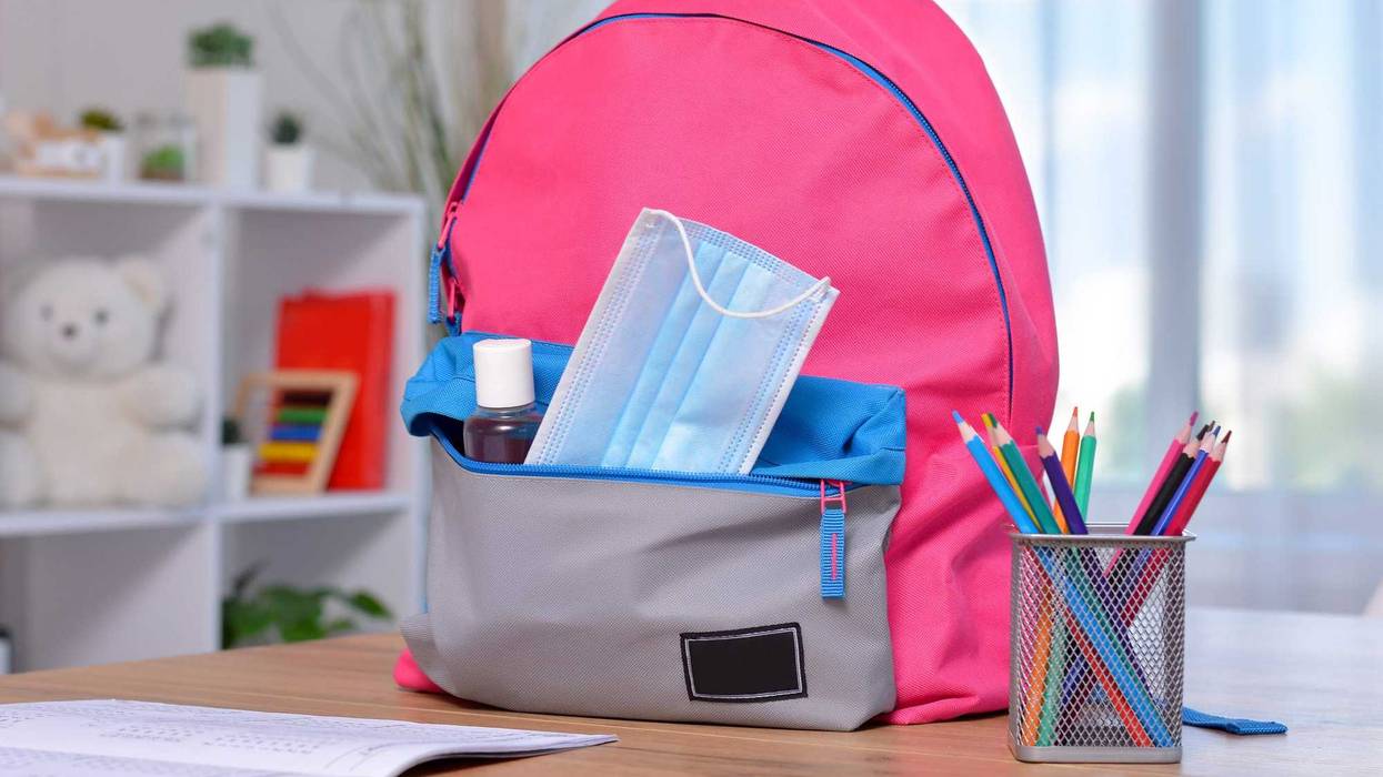 Mask in backpack pocket stock photo.