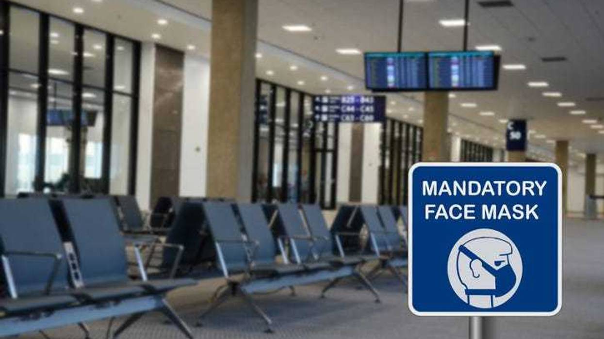 Mask mandate sign at an airport terminal.