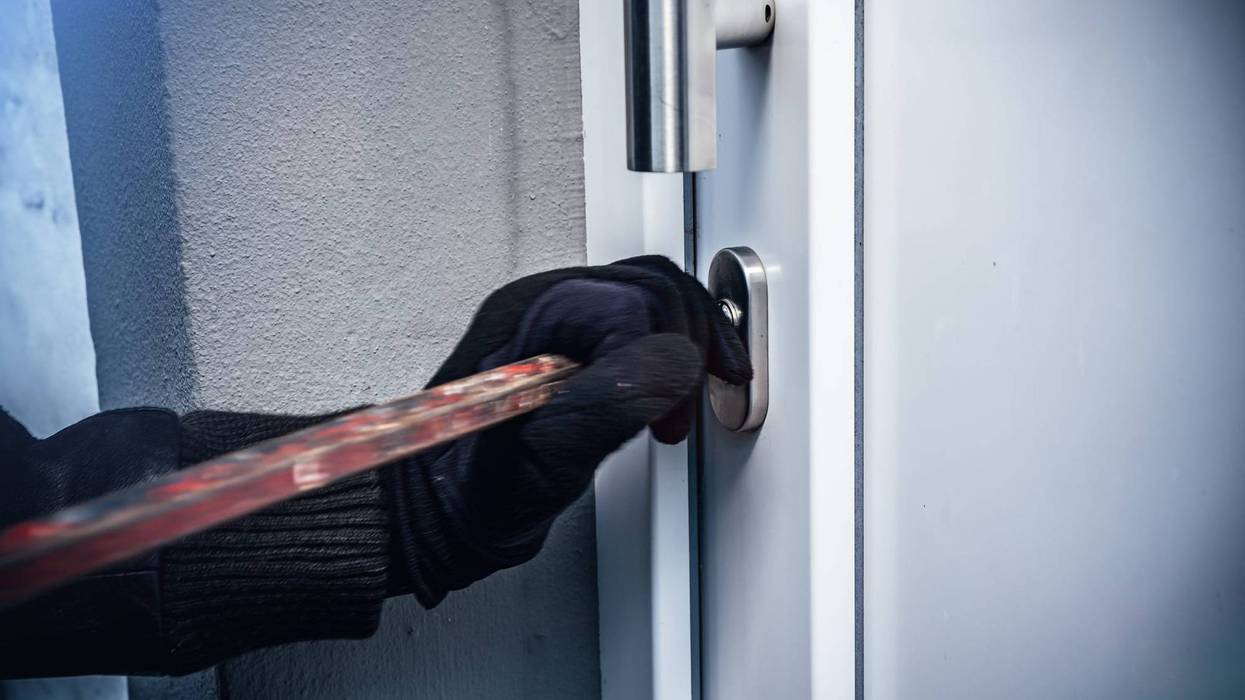 Masked burglars breaking and entering into a victim's home.