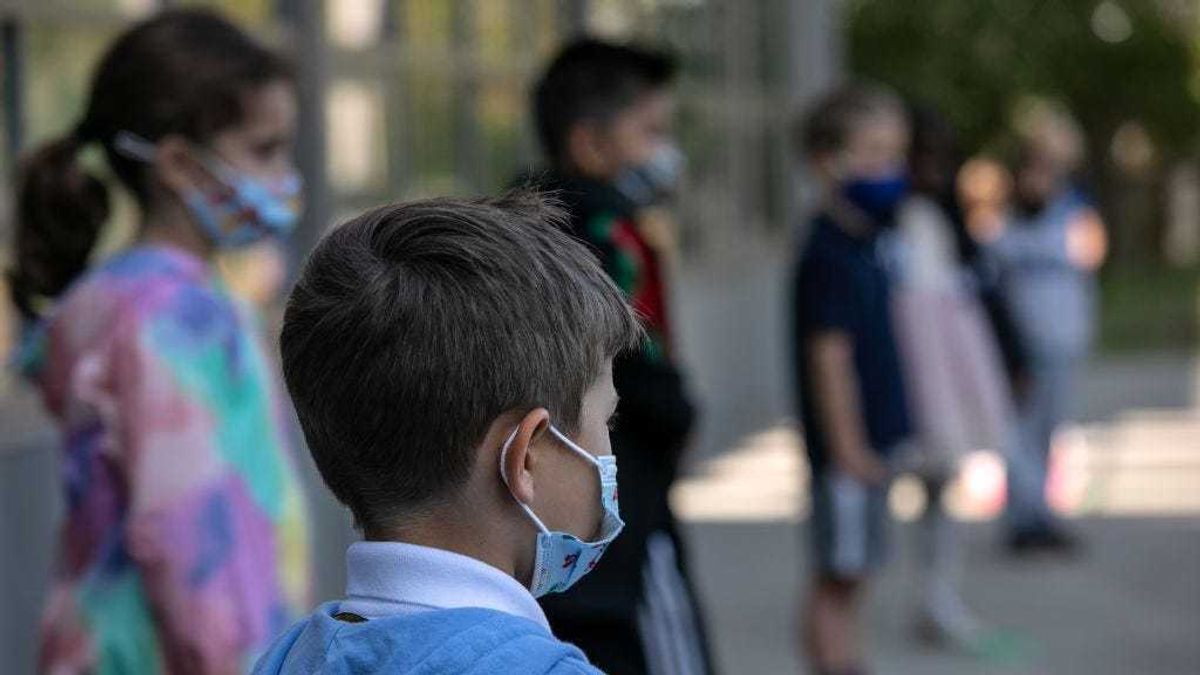 Masked school children wait to have their portraits taken during picture day at Rogers International School on September 23, 2020 in Stamford, Connecticut.