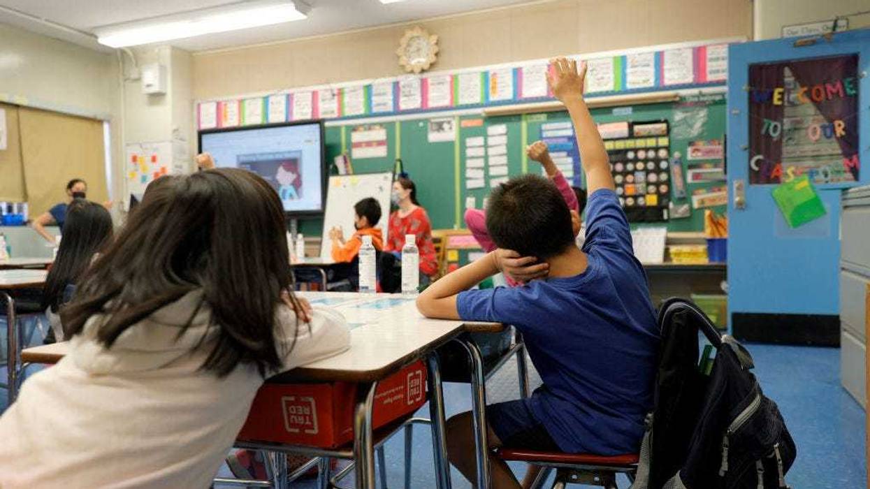 Masked students in their classroom.