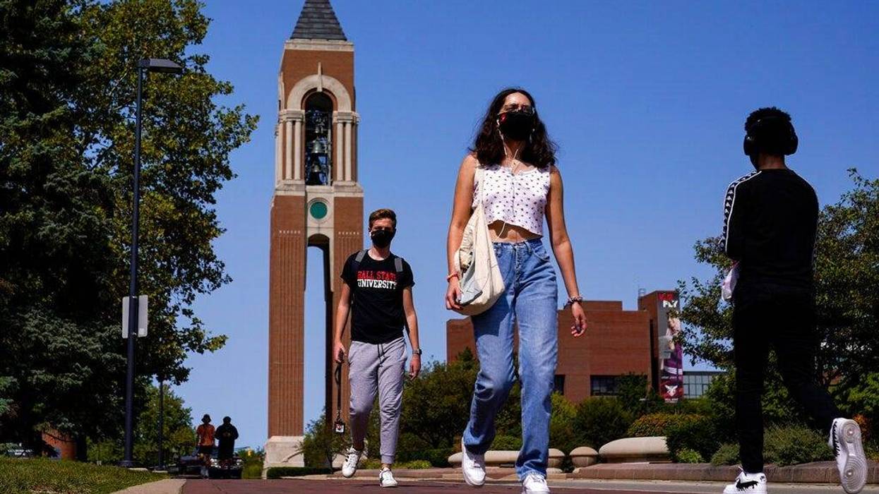 Masked students walk through the campus of Ball State University in Muncie, Indiana (AP)