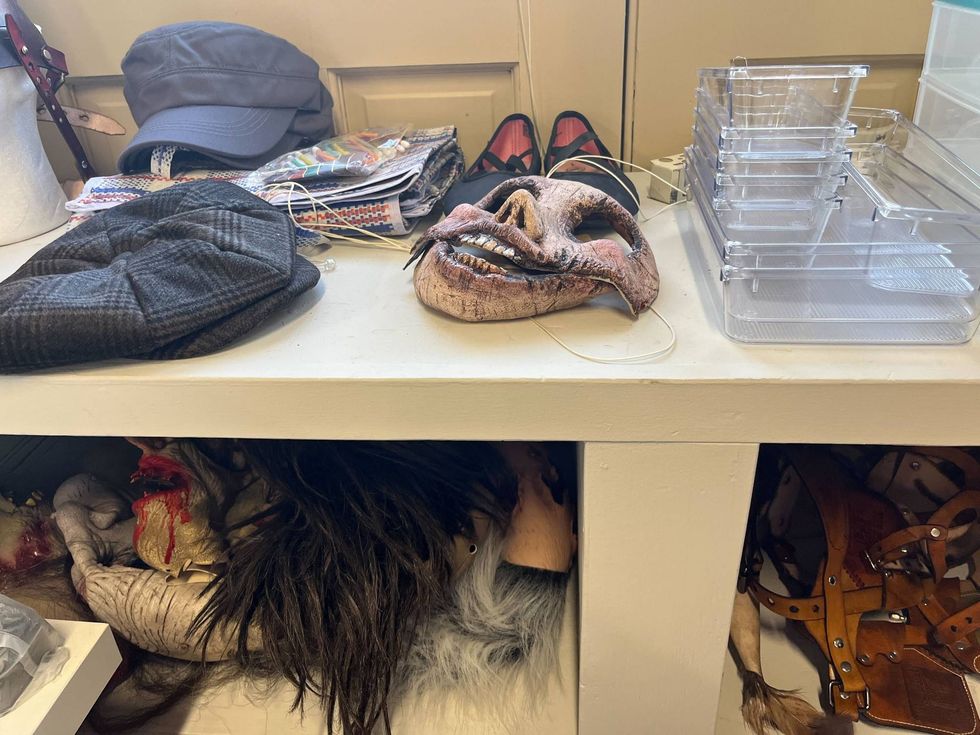 Masks, hats and wigs are strewn about in the Lincoln Mill dressing room.
