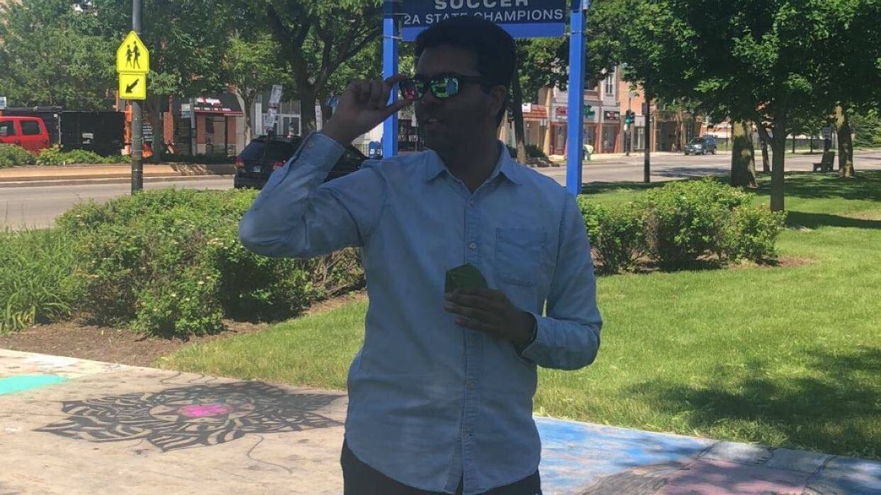 Mather High School Senior English Teacher Aneesh Shukla receives Enchroma glasses from his students