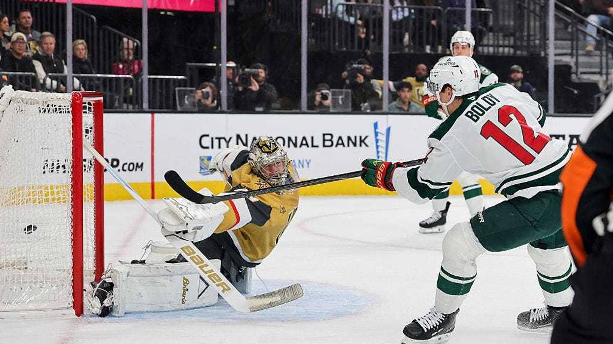 Matt Boldy #12 of the Minnesota Wild scores a goal against Carter Hart #79 of the Vegas Golden Knights in the first period of their game at T-Mobile Arena on December 29, 2025 in Las Vegas, Nevada. The Wild defeated the Golden Knights 5-2.