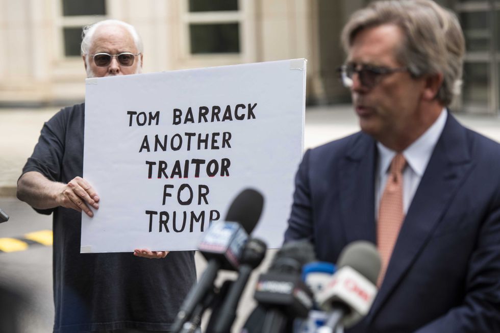 Matt Herrington, attorney for Tom Barrack Jr., founder of Colony Capital Inc., center, speaks to members of the media while departing from criminal court in New York, U.S., on Monday, July 26, 2021. Barrack pleaded not guilty to charges that he illegally lobbied the U.S. government on behalf of the United Arab Emirates and lied to investigators about it.