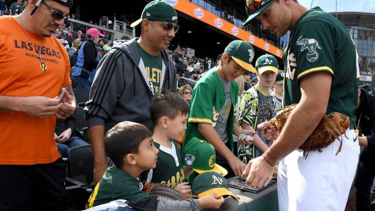 Matt Olson #28 of the Oakland Athletics signs autographs for fans before an exhibition game against the Cleveland Indians at Las Vegas Ballpark on February 29, 2020 in Las Vegas, Nevada.