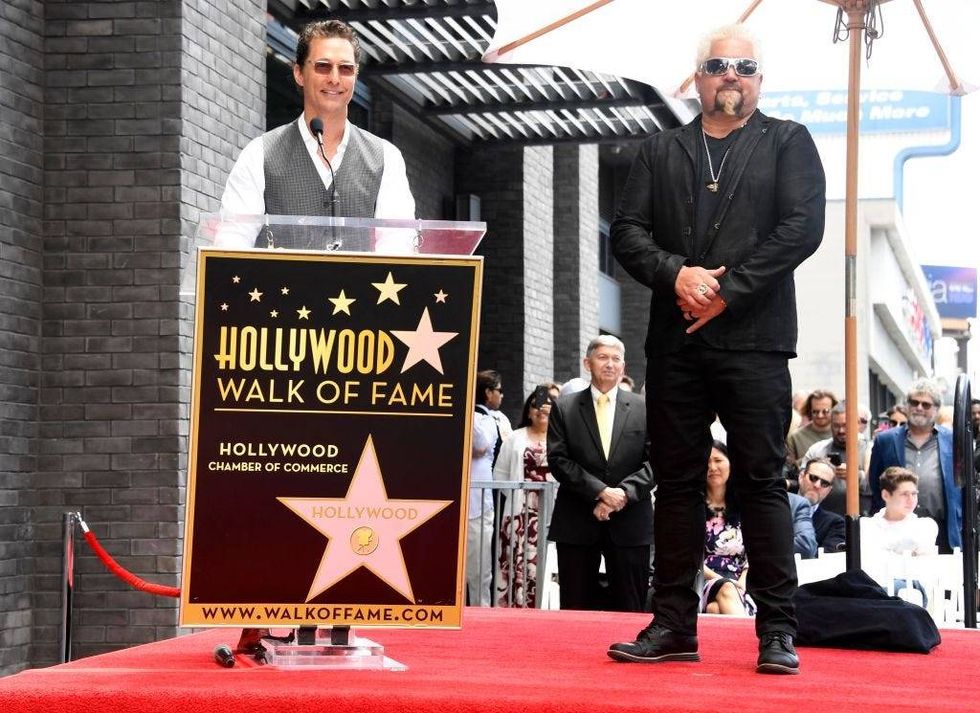 Matthew McConaughey (L) delivers remarks as Chef Guy Fieri (R) is honored with the 2,664th Star on the Hollywood Walk of Fame Star, in Hollywood, California in 2019.