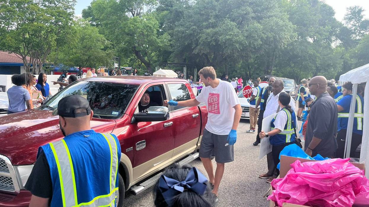 Mavericks' legend Dirk Nowitzki helps load cars with food at the Mark Cuban Heroes Basketball Center on Tuesday, May 7, 2024.