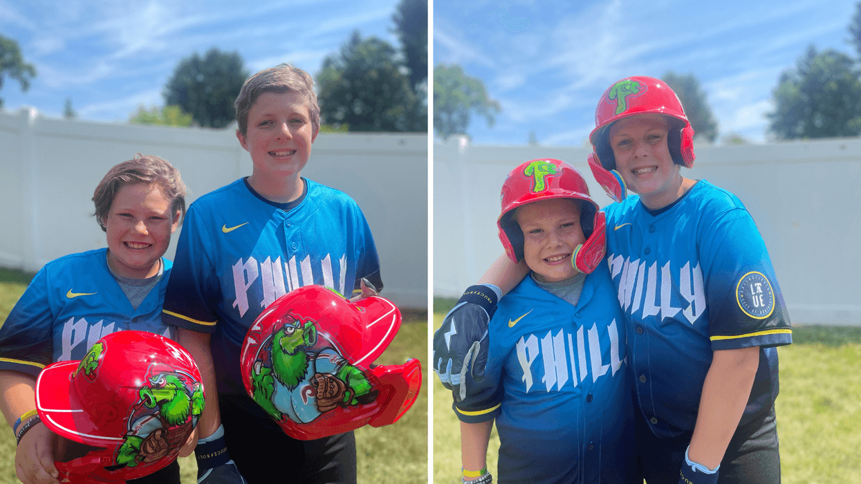 Max and LJ Schembri of Bucks County wearing custom made Phillies helmets from a family friend.