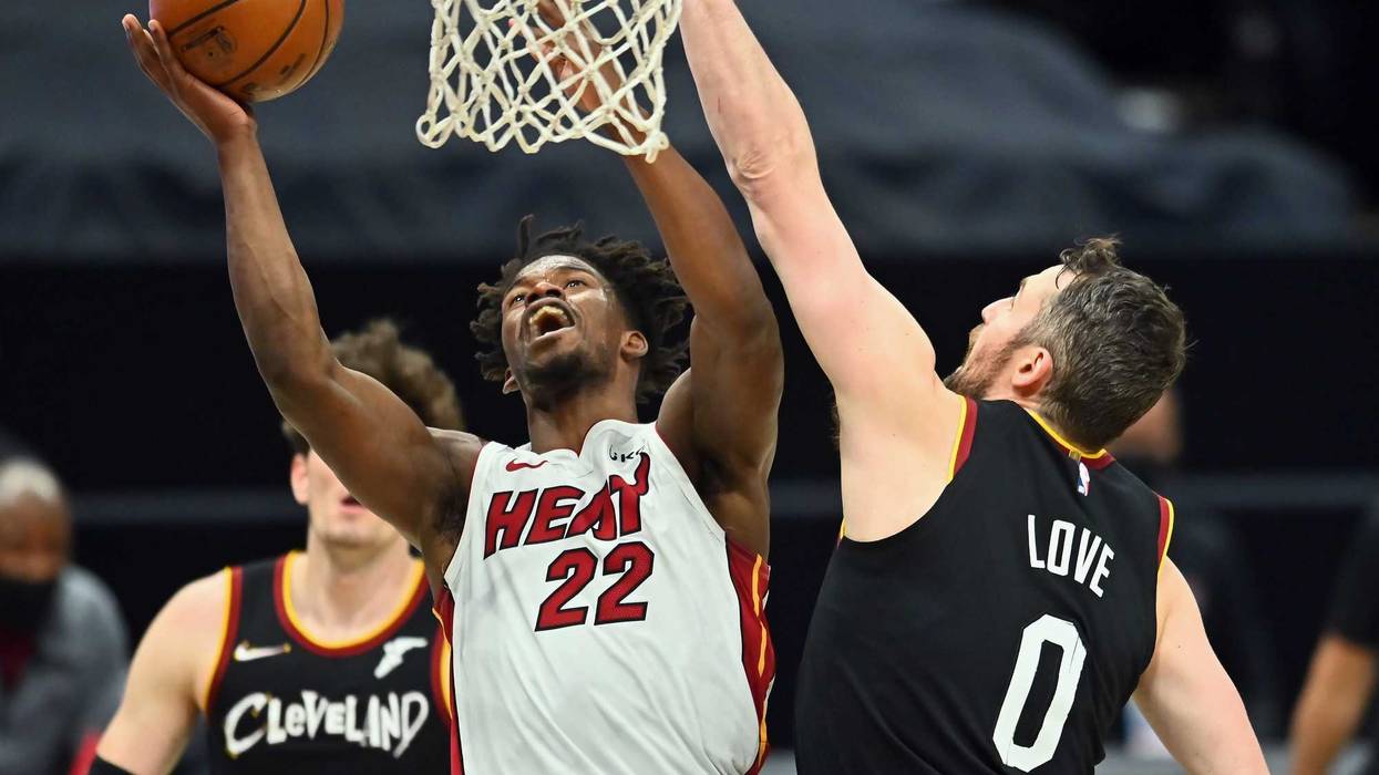 May 1, 2021; Cleveland, Ohio, USA; Miami Heat forward Jimmy Butler (22) drives to the basket against Cleveland Cavaliers forward Kevin Love (0) during the third quarter at Rocket Mortgage FieldHouse.