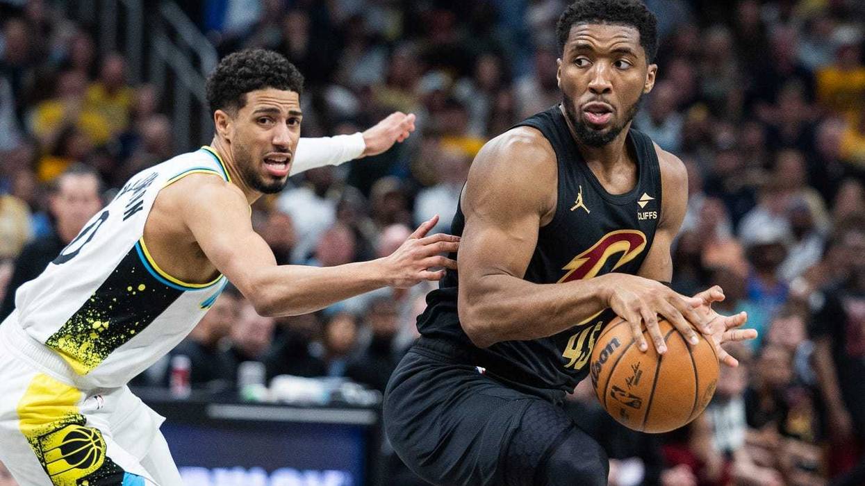 May 11, 2025; Indianapolis, Indiana, USA; Cleveland Cavaliers guard Donovan Mitchell (45) dribbles the ball while Indiana Pacers guard Tyrese Haliburton (0) defends during game four of the second round for the 2025 NBA Playoffs at Gainbridge Fieldhouse.