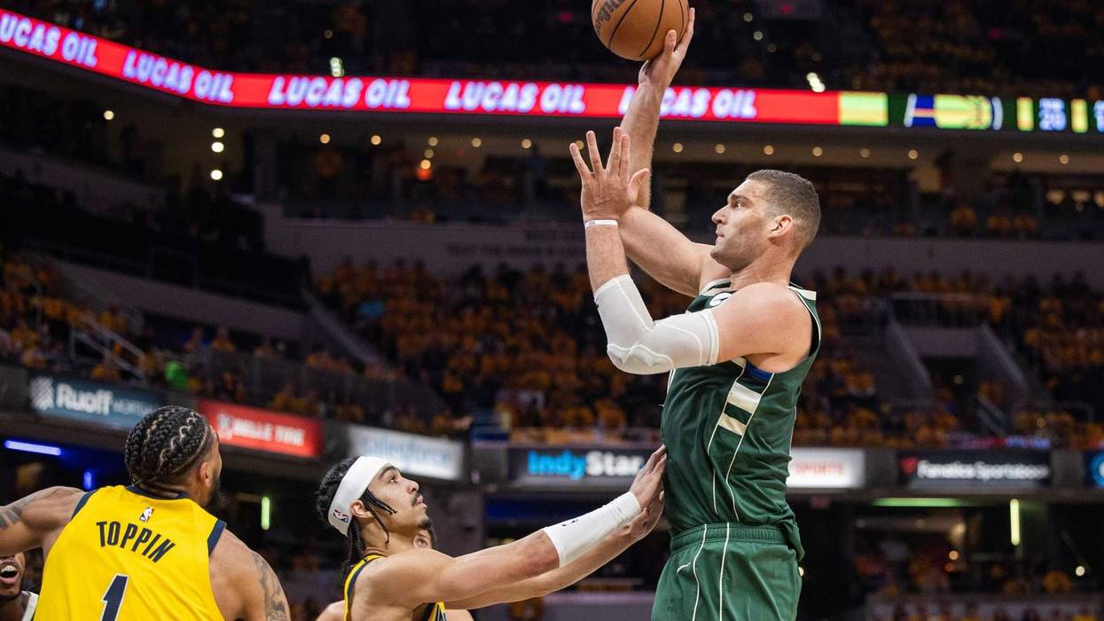 May 2, 2024; Indianapolis, Indiana, USA; Milwaukee Bucks center Brook Lopez (11) shoots the ball while Indiana Pacers guard Andrew Nembhard (2) defends during game six of the first round for the 2024 NBA playoffs at Gainbridge Fieldhouse. Mandatory Credit: Trevor Ruszkowski-USA TODAY Sports