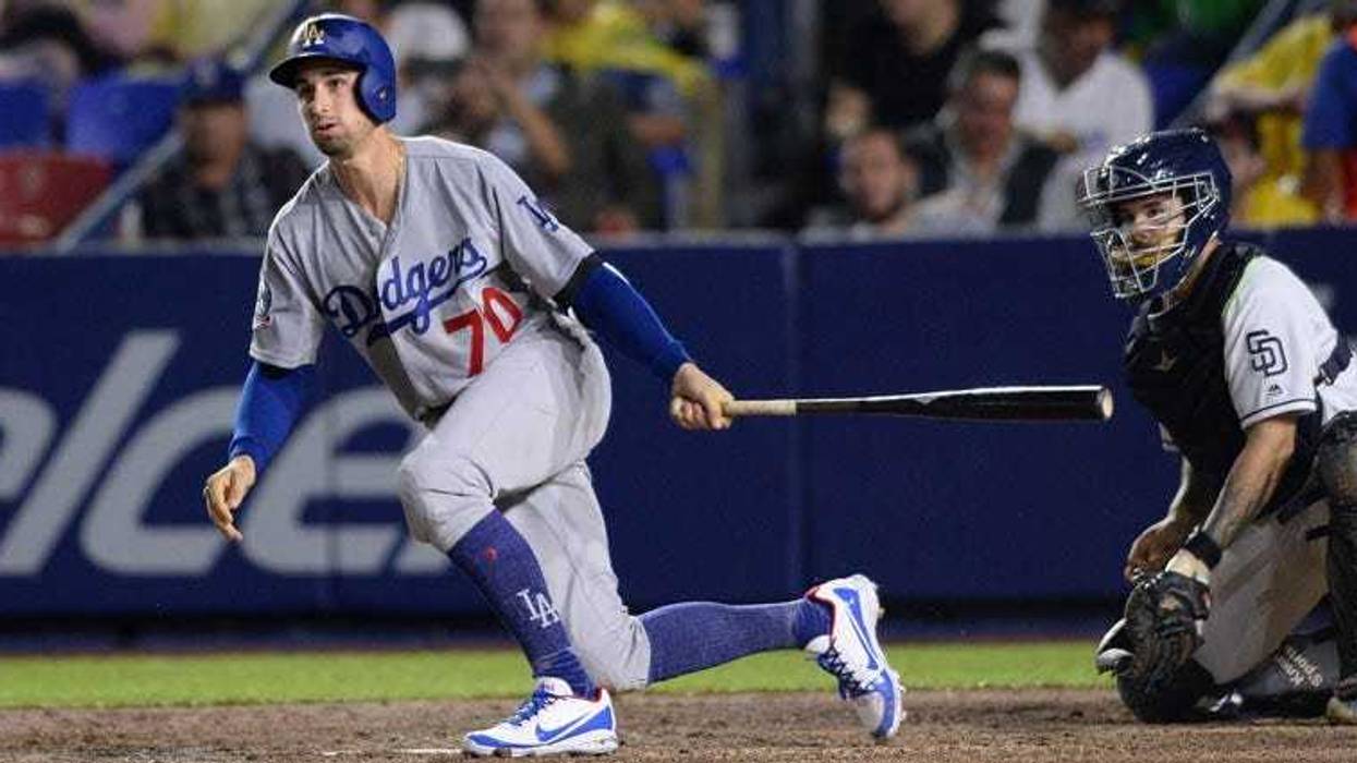 May 4, 2018; Monterrey, Nuevo Leon, Mexico; Los Angeles Dodgers center fielder Tim Locastro (70) watches his double ahead of San Diego Padres catcher Raffy Lopez (right) during the fourth inning. Orlando Ramirez-USA TODAY Sports