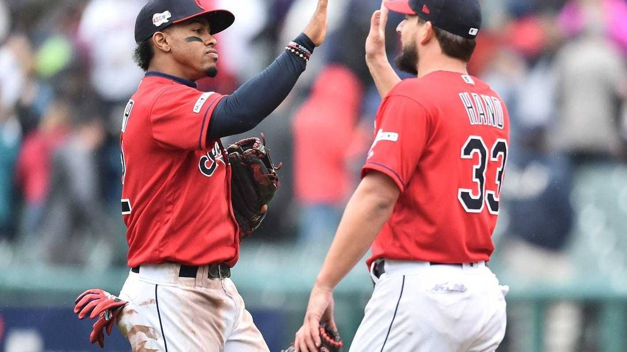 May 4, 2019; Cleveland, OH, USA; Cleveland Indians shortstop Francisco Lindor (12) and relief pitcher Brad Hand (33) celebrate after the Indians beat the Seattle Mariners at Progressive Field. Mandatory Credit: Ken Blaze-USA TODAY Sports